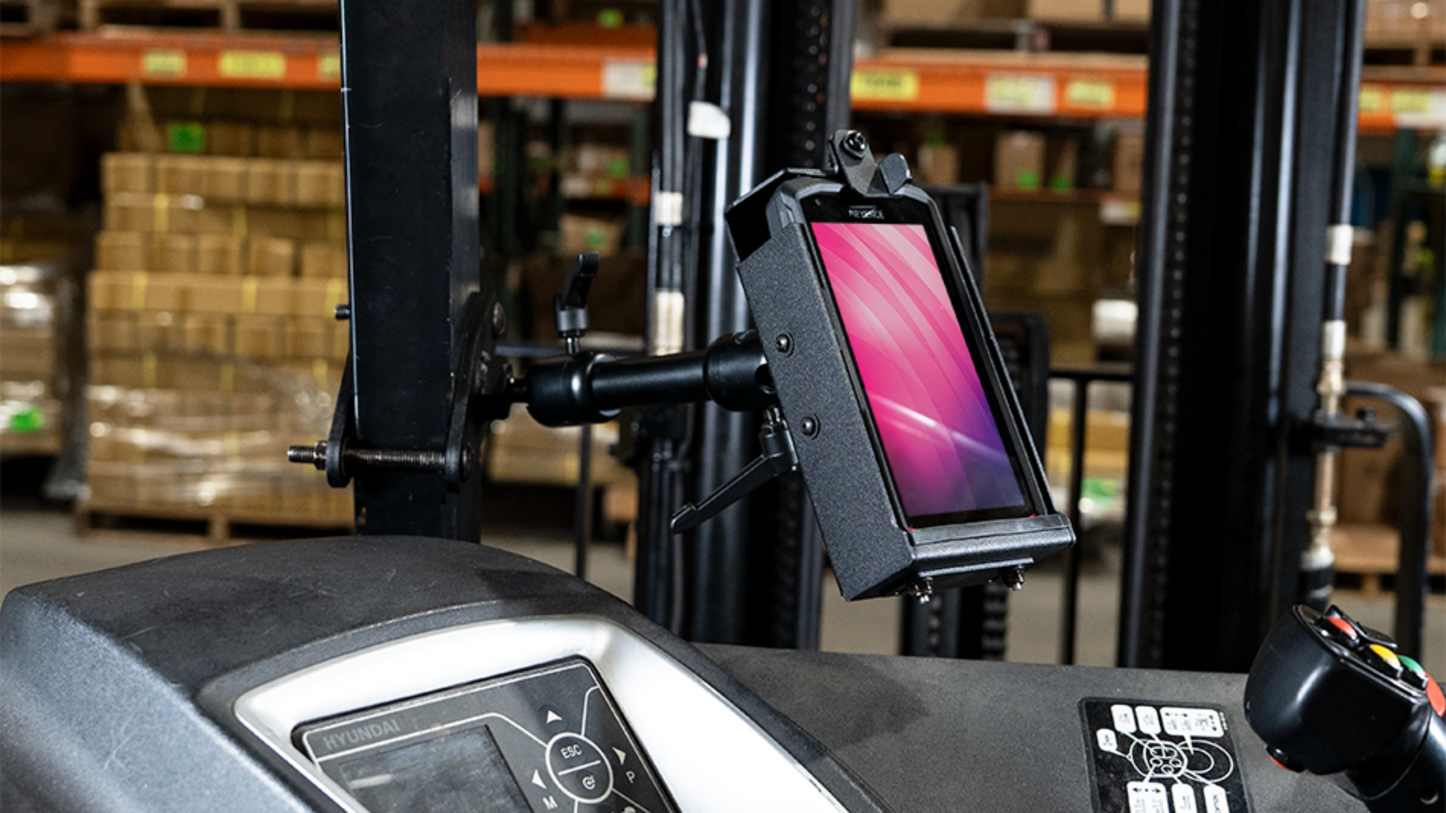 Gamber-Johnson KEYENCE DX-A600, DX-W600 Cradle with KEYENCE Device attached to a Gamber-Johnson Zirkona 4" Diamond Mount with 6" Medium Dog-Bone and AMPs Plate on a forklift